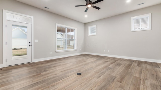 empty room featuring ceiling fan and light hardwood / wood-style flooring