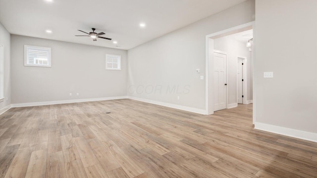 spare room featuring light hardwood / wood-style flooring and ceiling fan