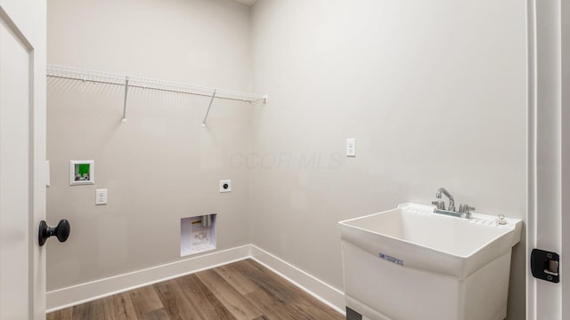 washroom with sink, hookup for a washing machine, hookup for an electric dryer, and hardwood / wood-style flooring