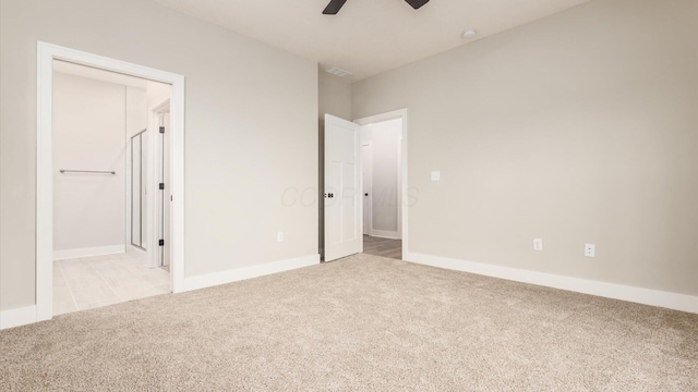 unfurnished bedroom with light colored carpet and ceiling fan