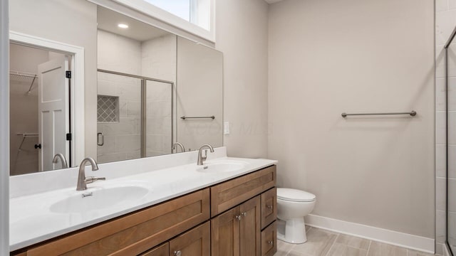 bathroom featuring walk in shower, vanity, and toilet