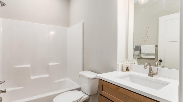 full bathroom featuring vanity, tub / shower combination, and toilet