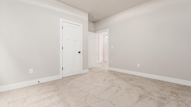 unfurnished room with light colored carpet