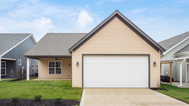 view of front of home with a garage and a front lawn