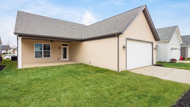 ranch-style home with a garage and a front lawn