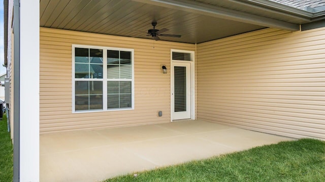 entrance to property featuring ceiling fan and a patio