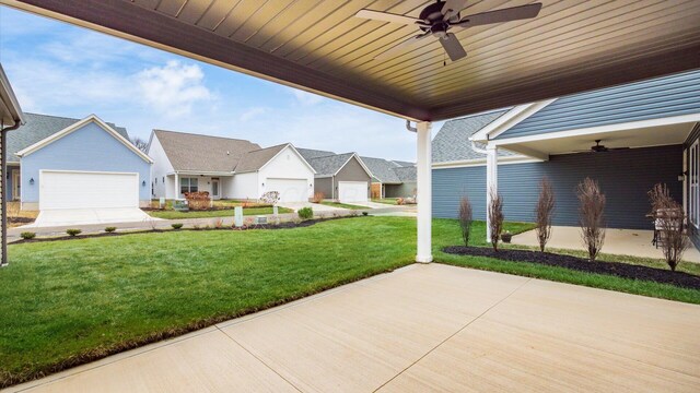 view of patio featuring a garage and ceiling fan