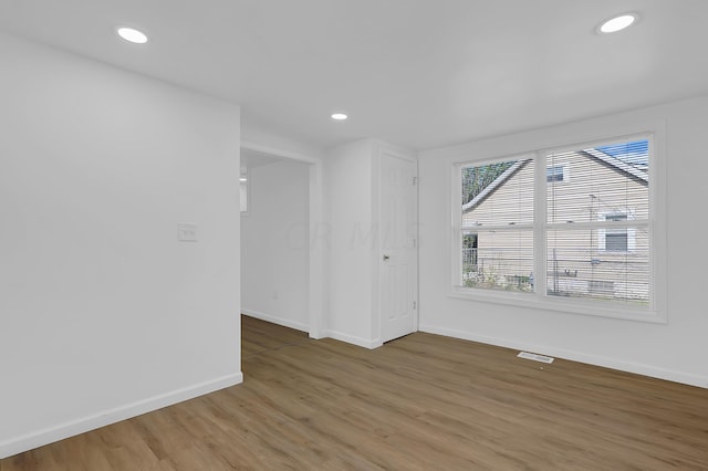 spare room with wood-type flooring