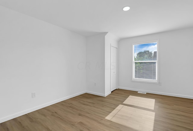 empty room with hardwood / wood-style floors