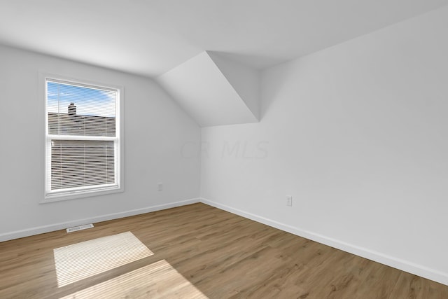 bonus room featuring hardwood / wood-style floors and vaulted ceiling