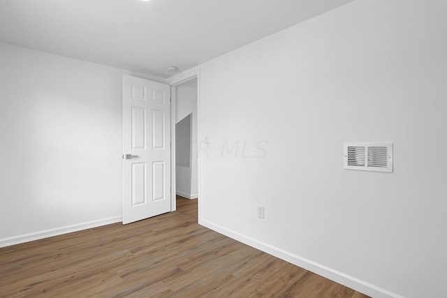 unfurnished room with hardwood / wood-style floors