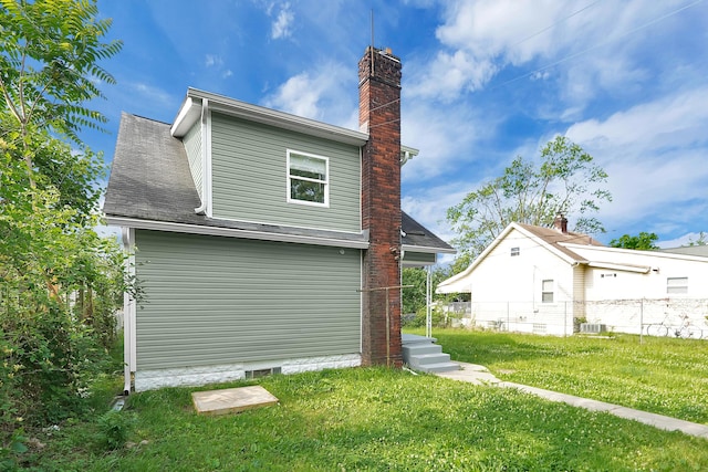 rear view of house with a yard