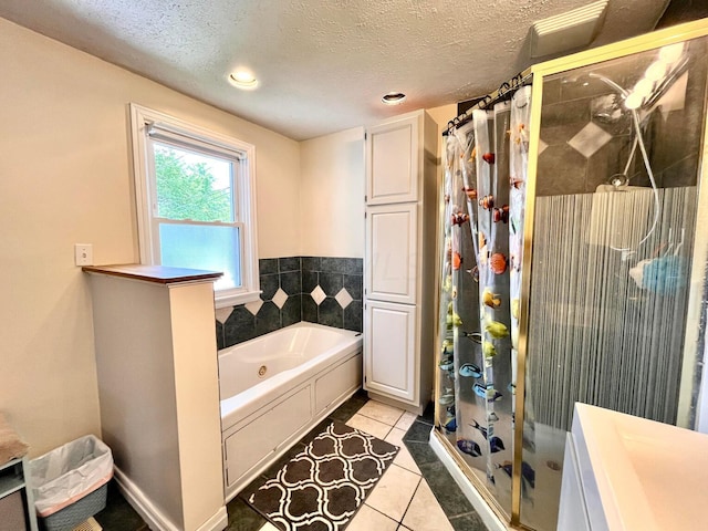 bathroom featuring tile patterned floors, independent shower and bath, and a textured ceiling