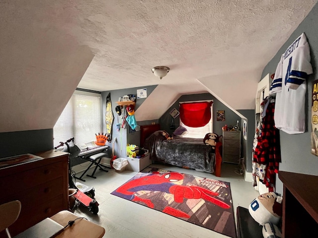 bedroom with lofted ceiling and a textured ceiling