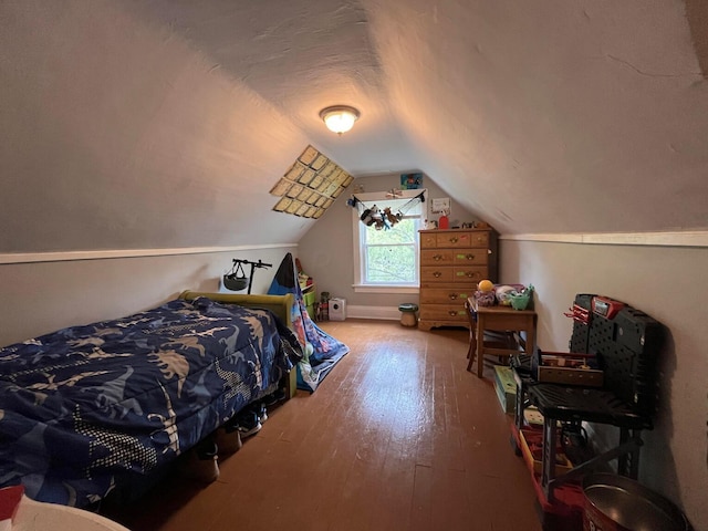 bedroom with hardwood / wood-style flooring and lofted ceiling