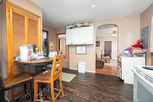 dining room with dark hardwood / wood-style floors and ceiling fan