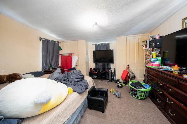 bedroom featuring light carpet and a textured ceiling