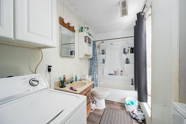 washroom featuring sink, wood-type flooring, and washer / dryer