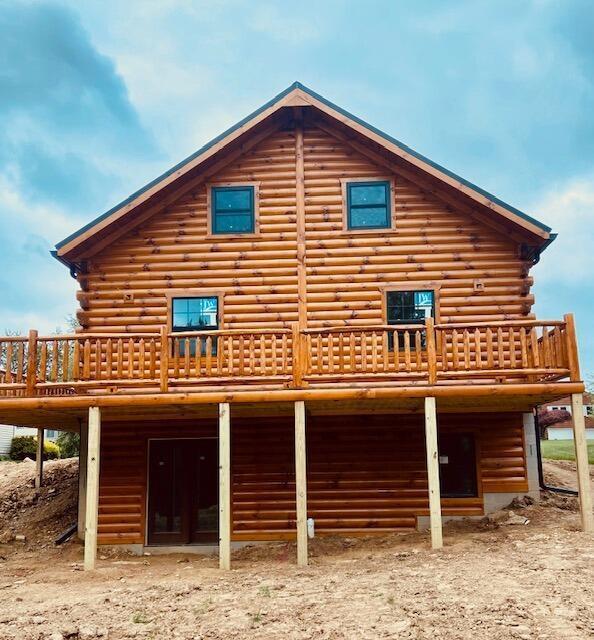 rear view of house with a wooden deck