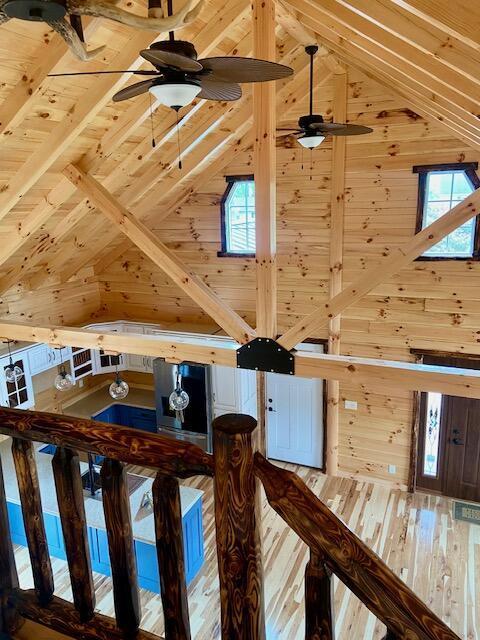 room details featuring hardwood / wood-style floors and wooden walls