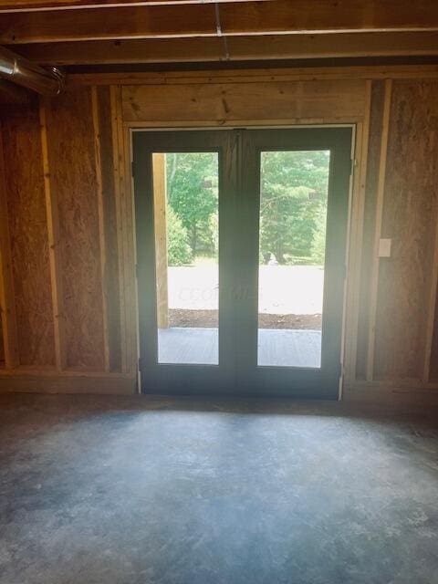 doorway to outside featuring french doors, concrete floors, and plenty of natural light