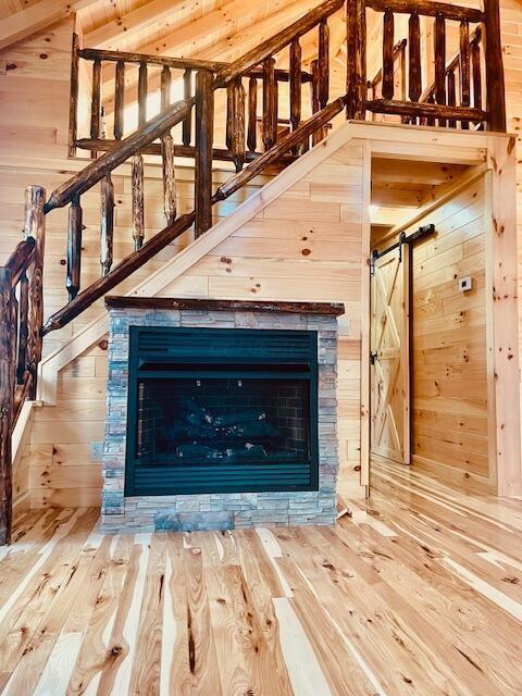 interior details with hardwood / wood-style floors and wood walls