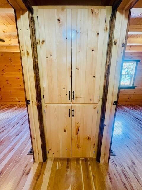 interior space featuring hardwood / wood-style flooring and wood walls