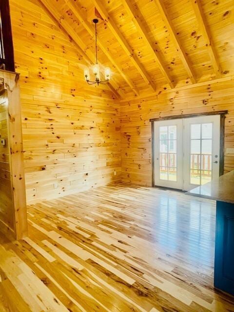 interior space featuring vaulted ceiling with beams, wooden walls, hardwood / wood-style floors, and wooden ceiling