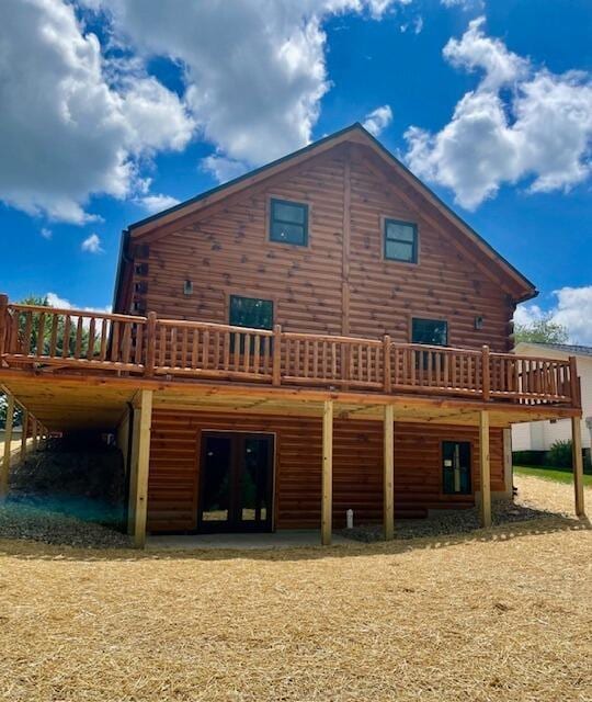 back of house featuring a deck