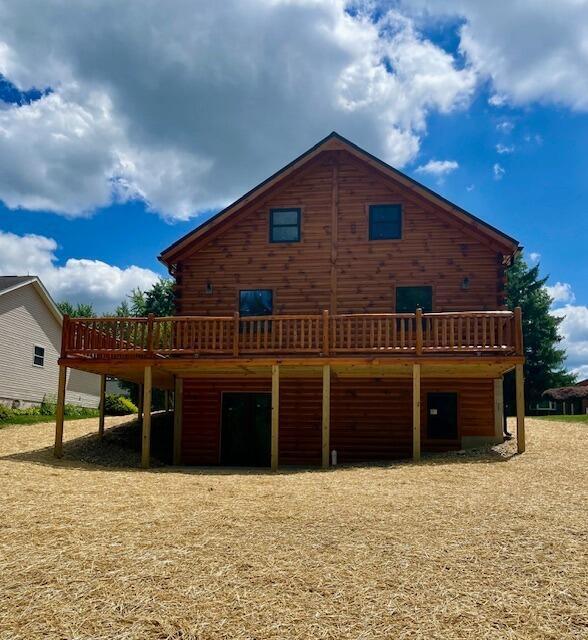 rear view of house featuring a wooden deck