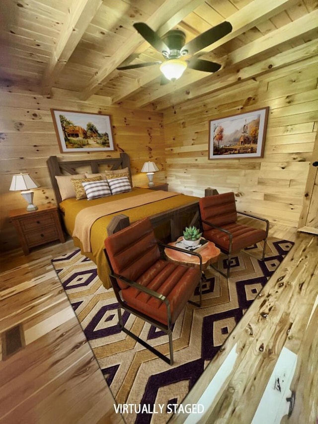 bedroom featuring wood walls, ceiling fan, beam ceiling, and light hardwood / wood-style floors