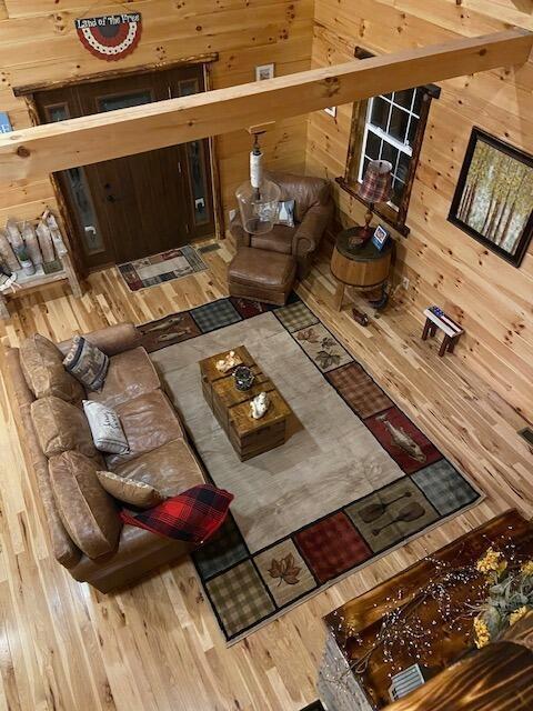 living room featuring wood walls and wood finished floors
