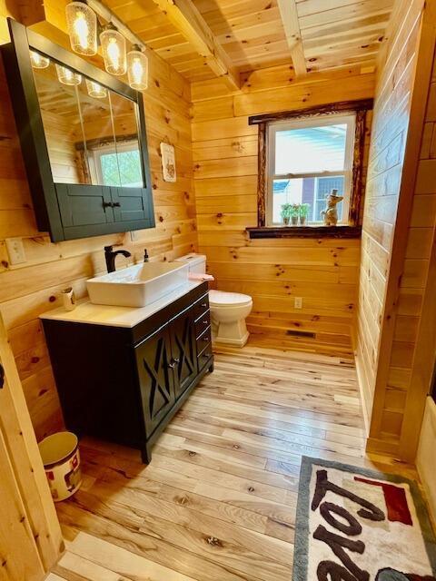 bathroom featuring plenty of natural light, wood ceiling, and hardwood / wood-style flooring