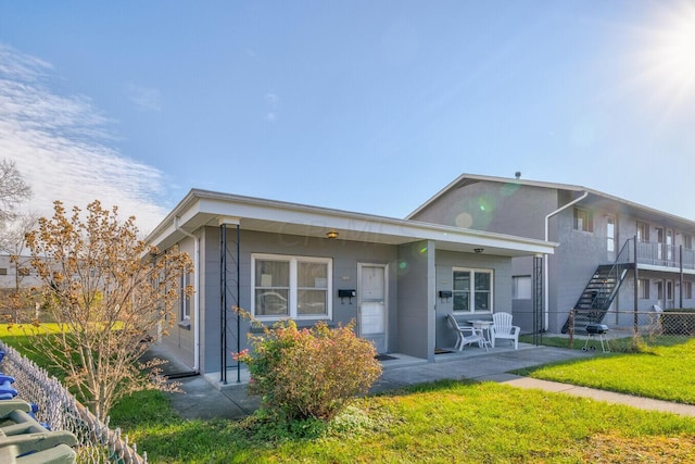 back of property with a patio area and a yard