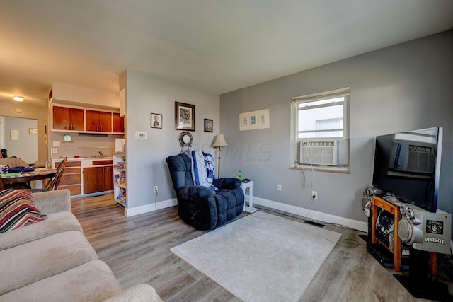 living room with light wood-type flooring and cooling unit