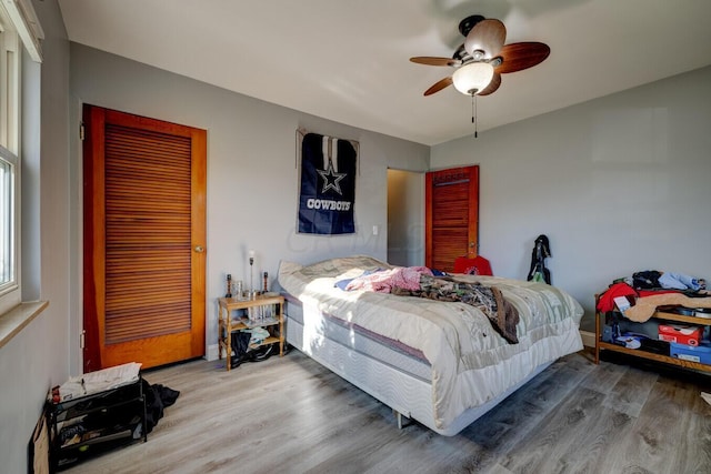 bedroom featuring hardwood / wood-style floors and ceiling fan