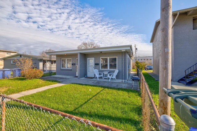 back of house with a yard and a patio area