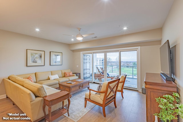 living room with light wood-type flooring and ceiling fan