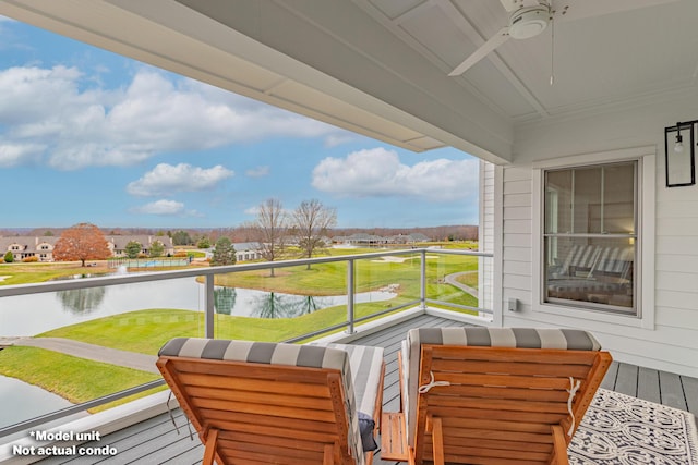 balcony with a water view and ceiling fan