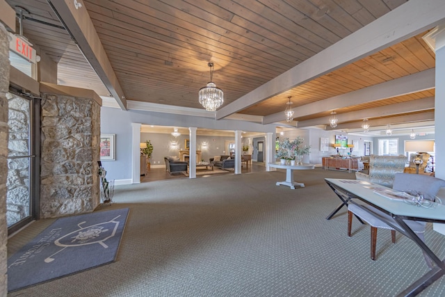 interior space with carpet, a notable chandelier, beam ceiling, wood ceiling, and decorative columns