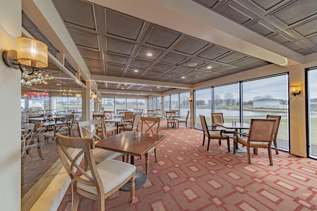 sunroom / solarium featuring a water view