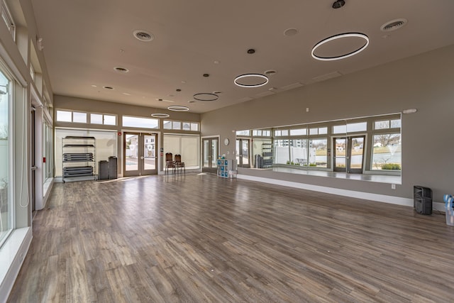 workout area featuring hardwood / wood-style flooring and french doors