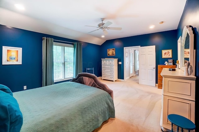 carpeted bedroom featuring ceiling fan and vaulted ceiling