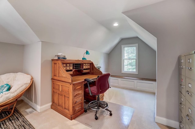 carpeted office space featuring vaulted ceiling