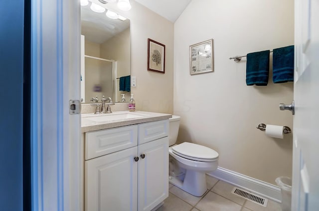 bathroom featuring tile patterned flooring, vanity, an enclosed shower, and toilet