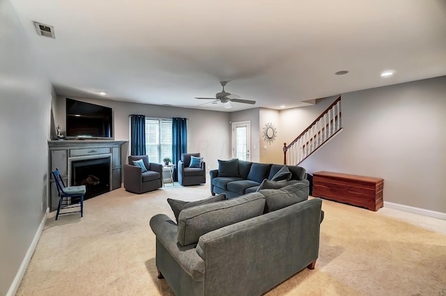 living room featuring ceiling fan and light carpet