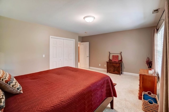 bedroom featuring a closet and light colored carpet