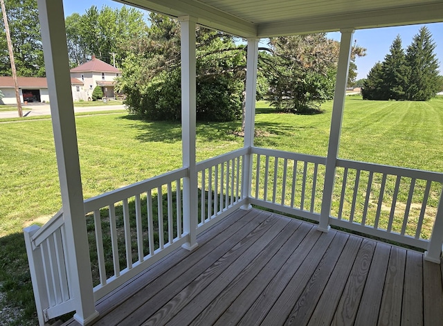 deck featuring a lawn and a porch