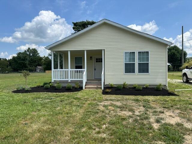 view of front of property with a front yard and covered porch