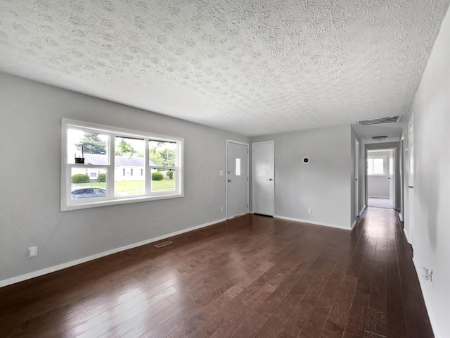 interior space featuring dark hardwood / wood-style floors and a textured ceiling